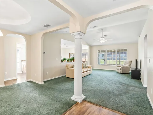 a view of a livingroom with furniture and an entryway