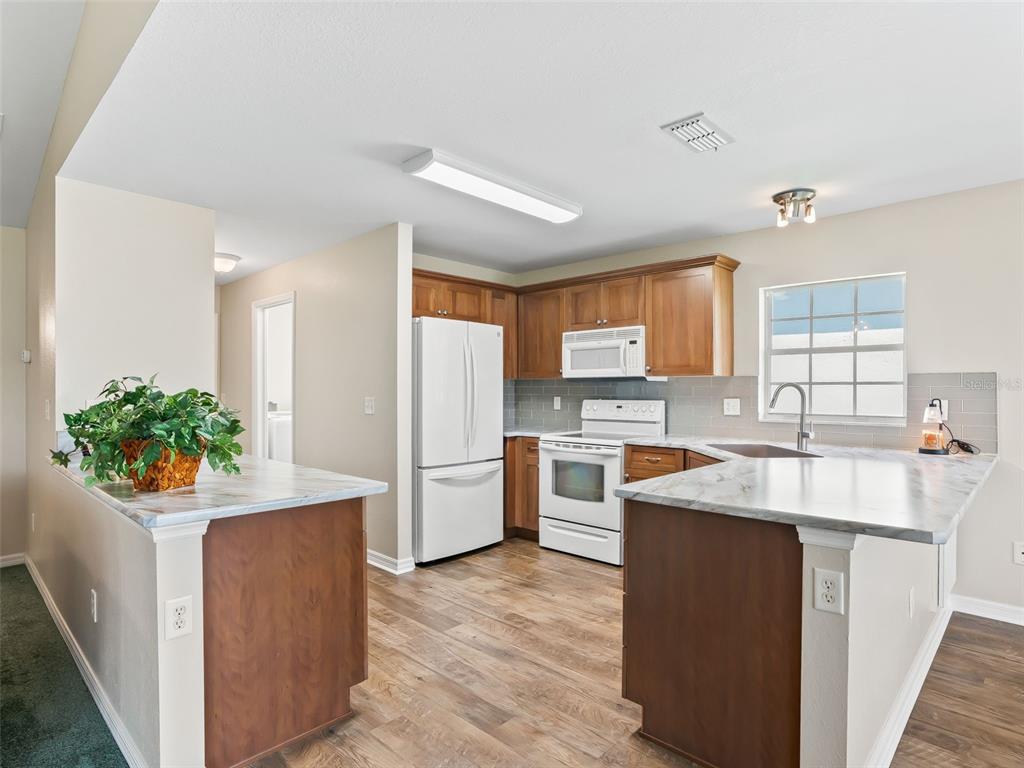 12321 Southeast 176th Loop Summerfield, FL 34491 - Photo 10 of 51 a kitchen with refrigerator and cabinets
