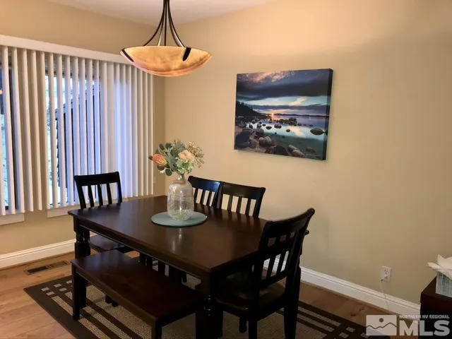 a view of a dining room with furniture and window