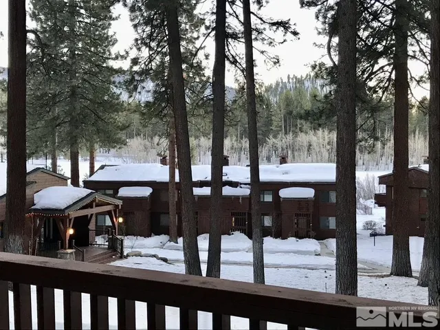 a view of a patio with chairs and table of the ocean