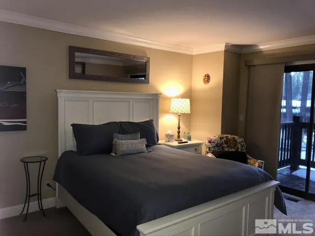 a bedroom with a bed and a potted plant