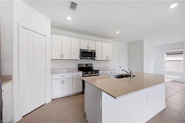 a kitchen that has a sink and a stove in it