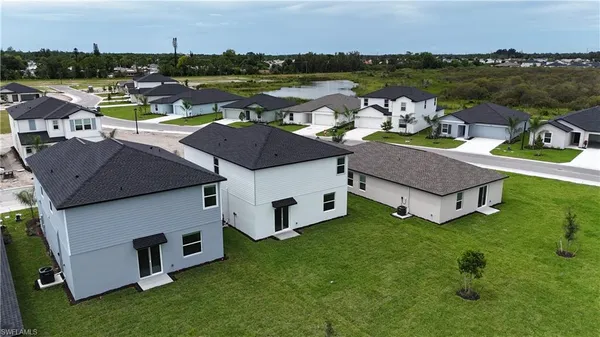 an aerial view of a house with outdoor space and lake view