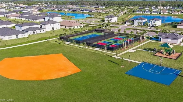 an aerial view of residential houses with outdoor space and pool