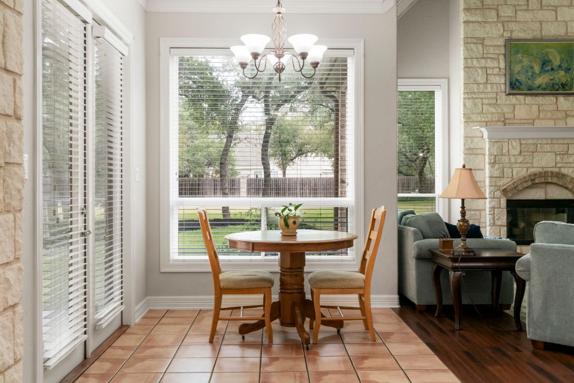 209 Goldridge Drive Georgetown, TX 78633 - Photo 16 of 40 a dining room with furniture a chandelier and wooden floor
