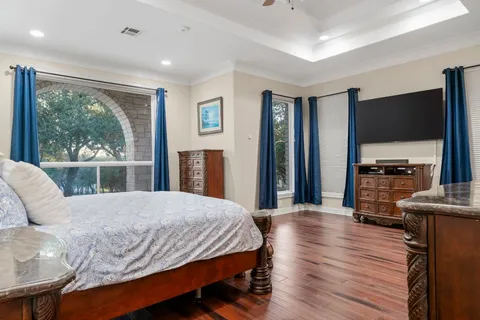 a bedroom with a bed and a television in it