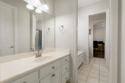 a bathroom with a sink a vanity and a mirror