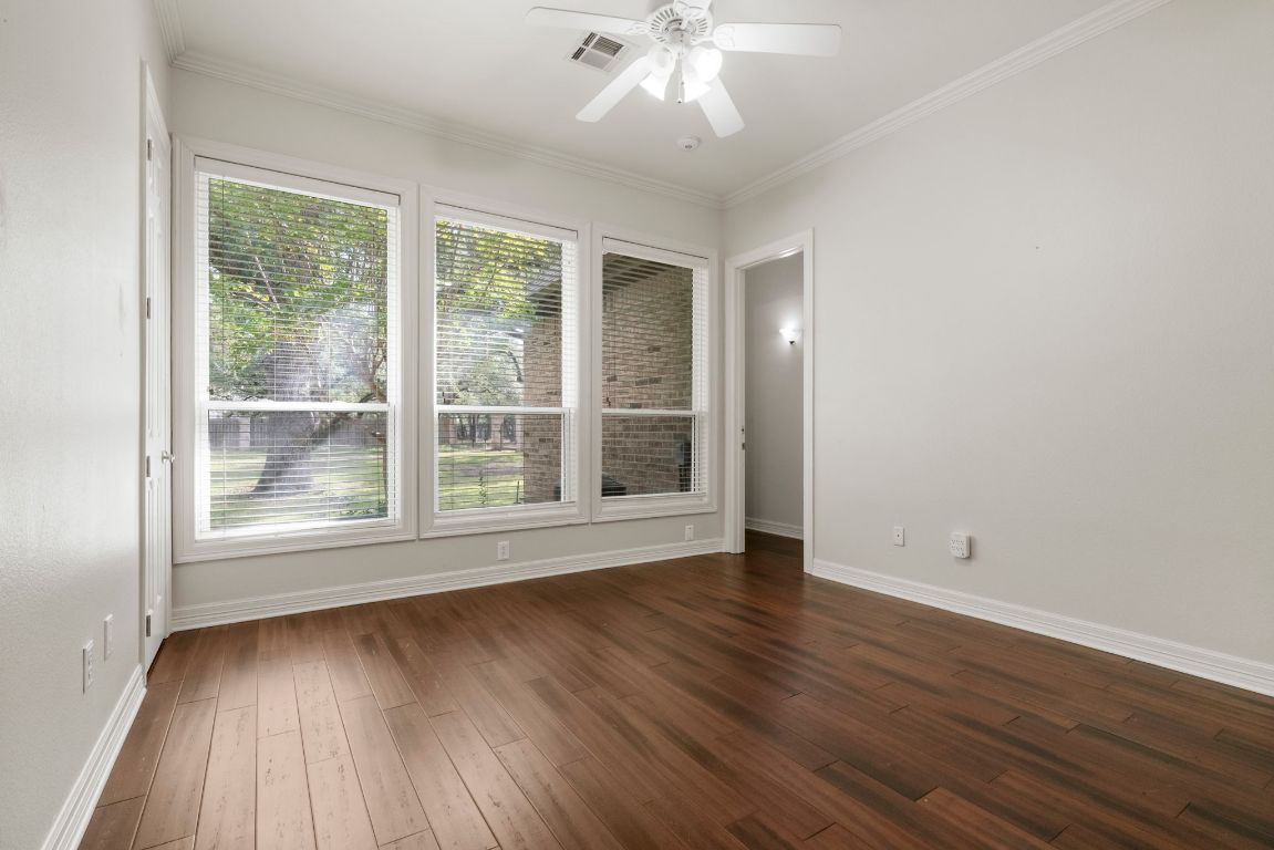209 Goldridge Drive Georgetown, TX 78633 - Photo 31 of 40 a view of an empty room with wooden floor and a window