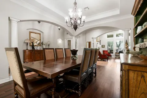 a view of a dining room with furniture and wooden floor