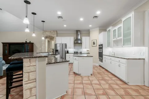 a kitchen with a sink appliances and cabinets
