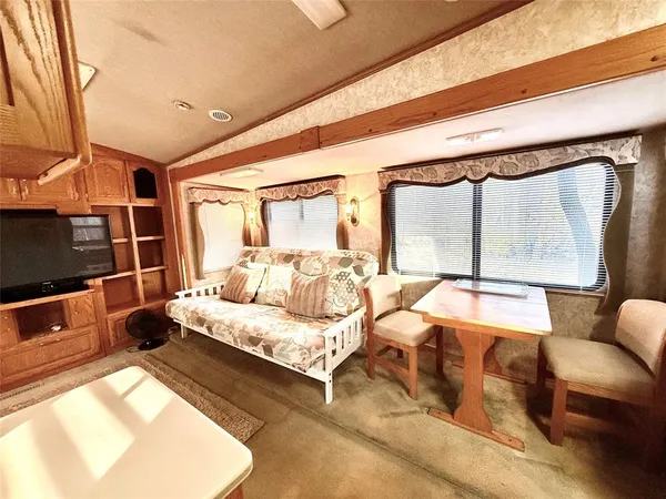 a bedroom with furniture and a large window