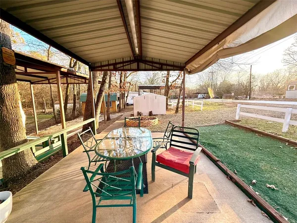 a view of a patio with table and chairs and wooden floor