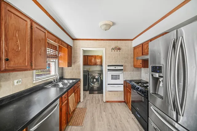 a kitchen with stainless steel appliances a refrigerator stove and sink