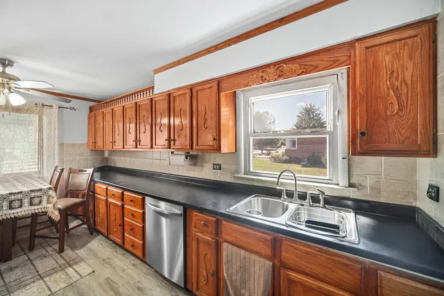 a kitchen with stainless steel appliances a sink stove and cabinets