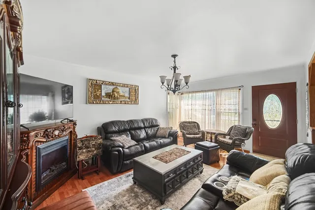 a living room with furniture ceiling fan and a window