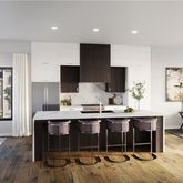 a view of a dining room with furniture a kitchen and chandelier