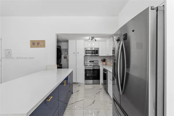 a kitchen with a refrigerator and a sink