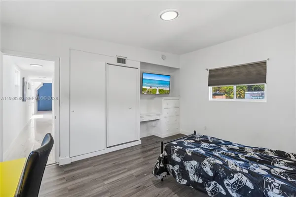 a bedroom with bed and a window