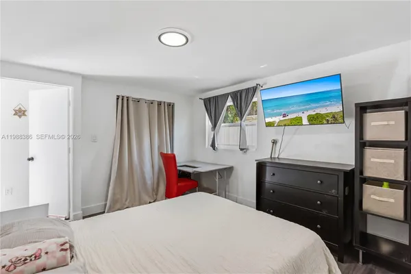 a bedroom with a bed and a dresser