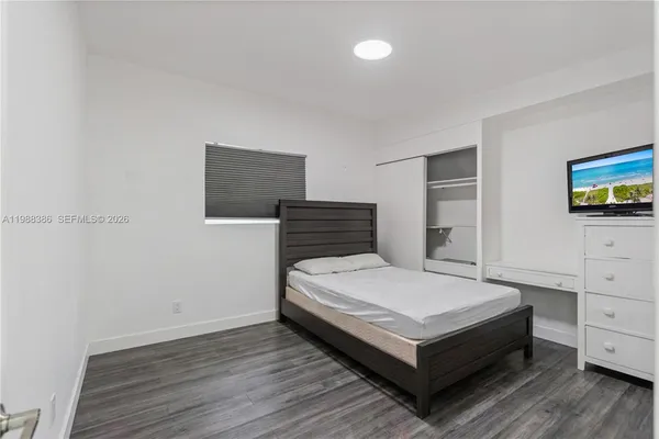 a large bed sitting in a bedroom and dresser