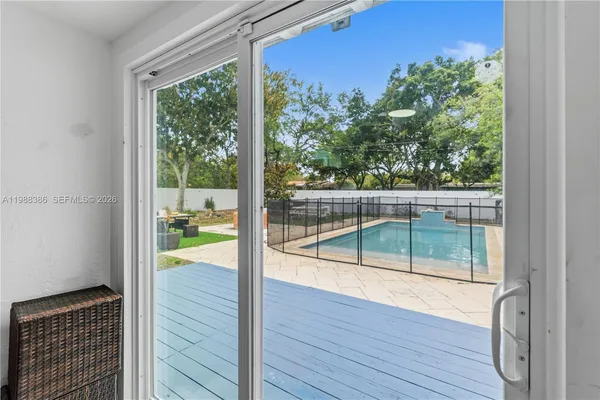 a view of a room with wooden floor and a tub
