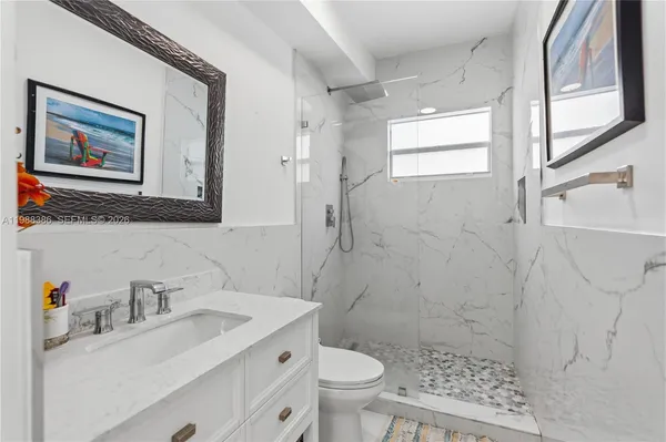 a bathroom with a sink toilet and shower