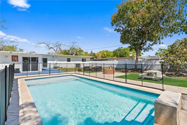 a view of lake with a big yard and large trees
