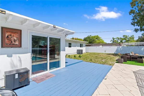 an aerial view of residential houses with outdoor space and city view
