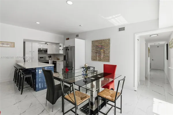 a view of a dining room with furniture and a window