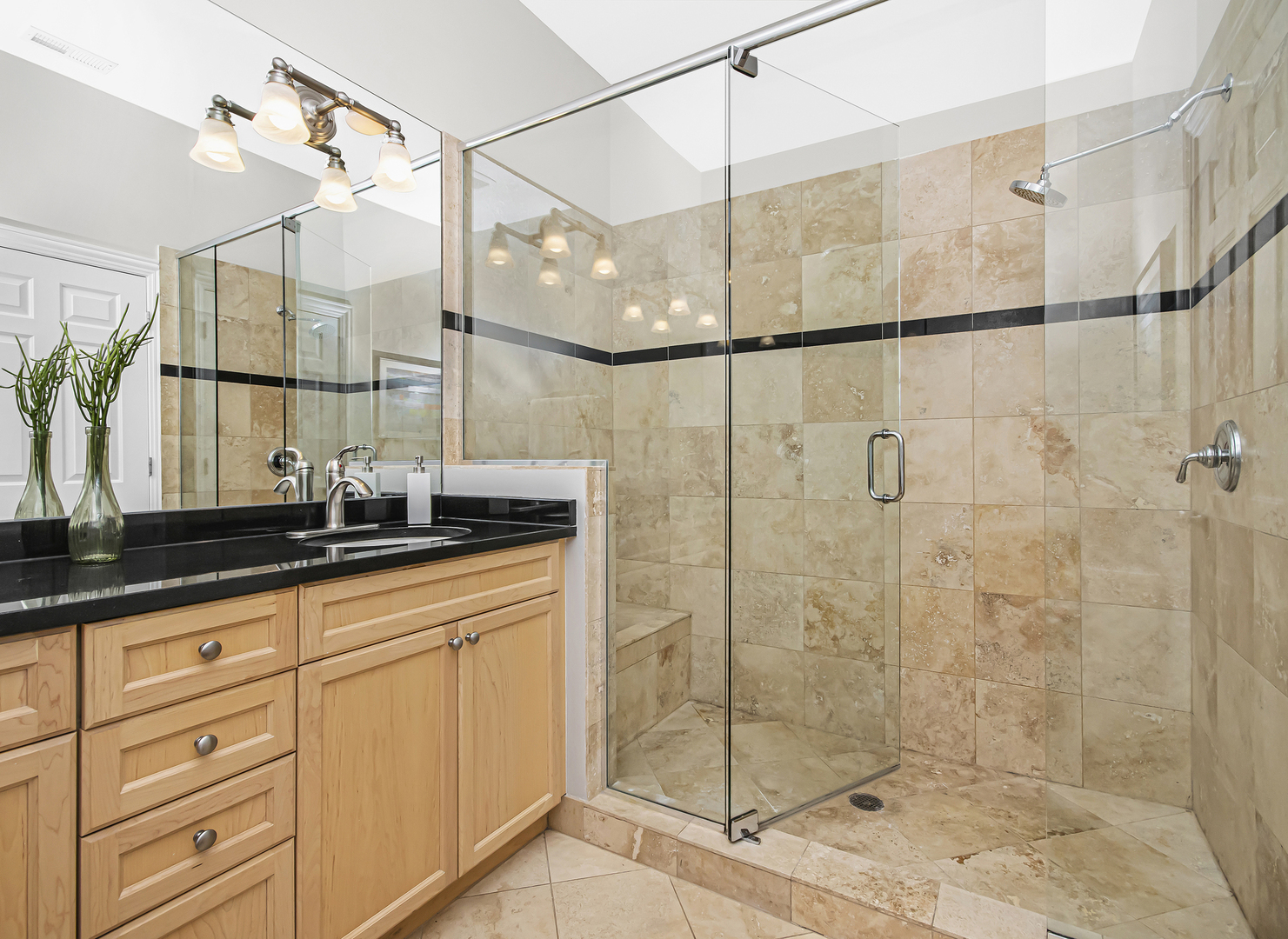 1908 West Irving Park Road, Unit 303 Chicago, IL 60613 - Photo 14 of 22 a bathroom with a granite countertop sink a mirror and shower