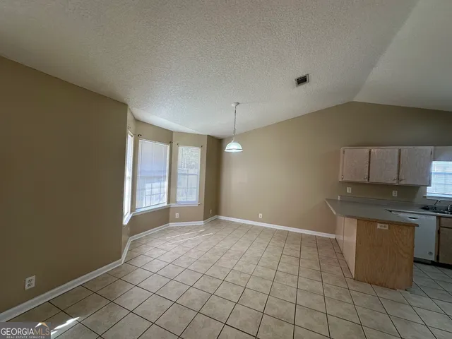 a view of a kitchen with a sink and dishwasher cabinets