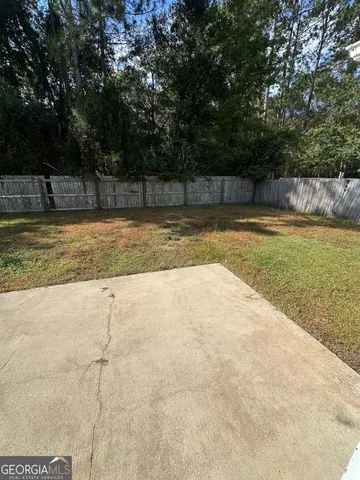 a view of a backyard with large trees