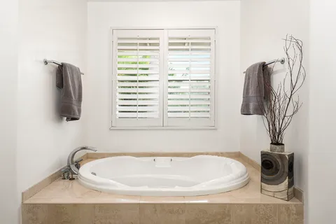 a bathroom with a bathtub and a window