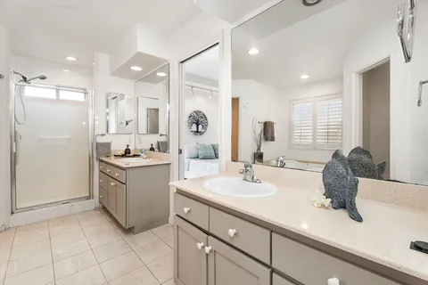 a bathroom with a granite countertop sink mirror and double
