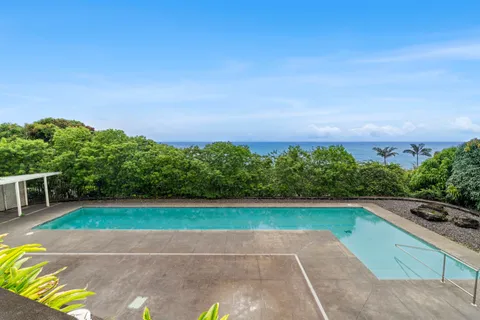 a view of yard with swimming pool and green space