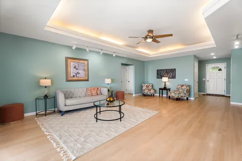 a living room with furniture and a gym machine