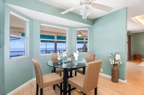a dining room with furniture a window and a chandelier