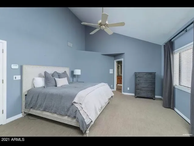 a living room with a bed furniture and a window