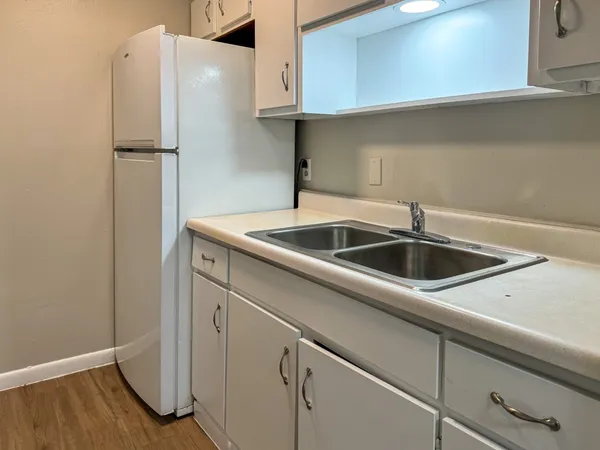 a white refrigerator freezer sitting inside of a kitchen