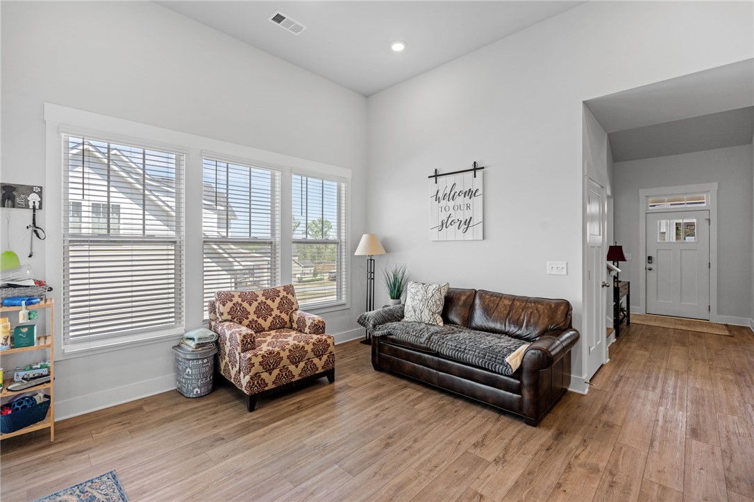 210 Maverick Trail Central, SC 29630 - Photo 16 of 41 This inviting living area features warm wood flooring and ample natural light through large windows.