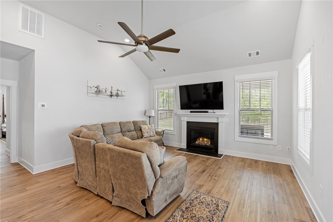 210 Maverick Trail Central, SC 29630 - Photo 18 of 41 This bright living room features high ceilings and a cozy fireplace, perfect for gatherings.