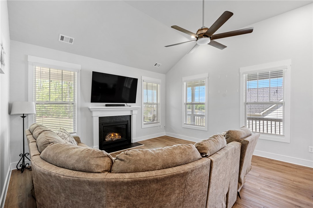 210 Maverick Trail Central, SC 29630 - Photo 19 of 41 This bright living space features abundant natural light, a fireplace, and high ceilings.