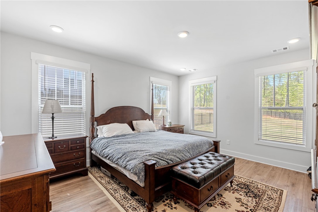 210 Maverick Trail Central, SC 29630 - Photo 22 of 41 This tranquil bedroom features abundant natural light and wood flooring, perfect for serene relaxation.