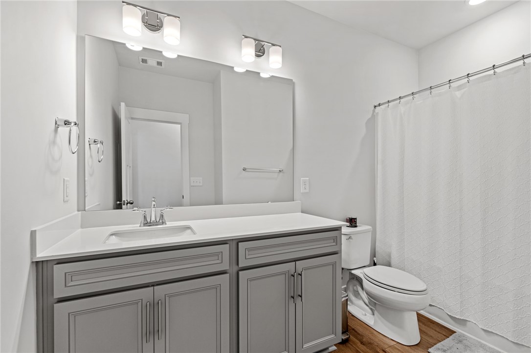 210 Maverick Trail Central, SC 29630 - Photo 26 of 41 This bathroom features a contemporary vanity with a spacious mirror and elegant light fixtures.