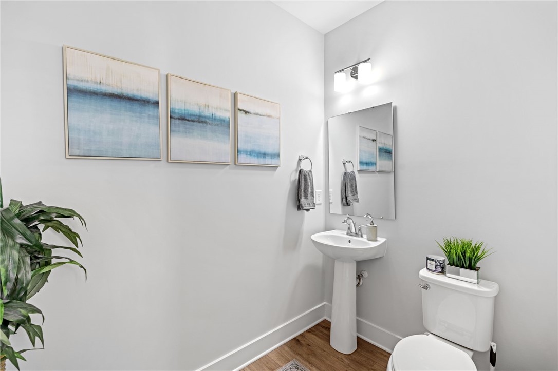 210 Maverick Trail Central, SC 29630 - Photo 8 of 41 This bright bathroom features a pedestal sink and modern fixtures, creating a crisp, clean aesthetic.