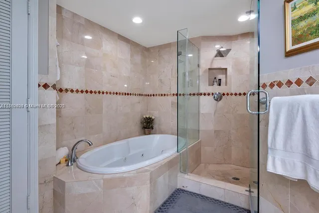a bathroom with a tub and a shower