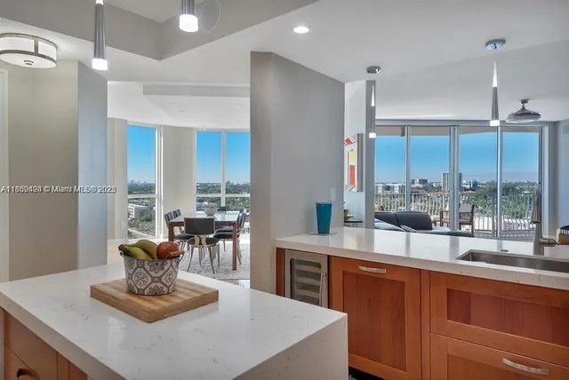 a kitchen with a stove a refrigerator and a dining table with wooden floor