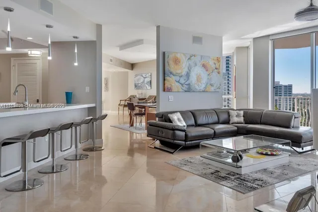 a living room with furniture and a large window