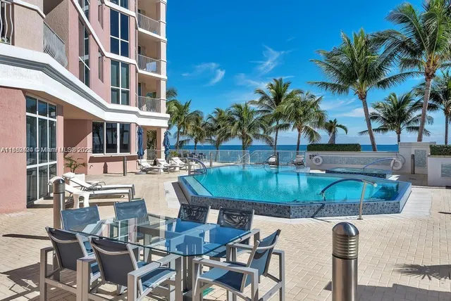 a view of a patio with table and chairs
