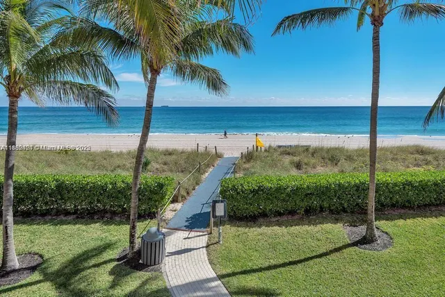a view of a living room and kitchen with a large window